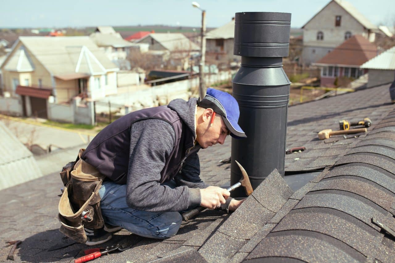 a-professional-master-roofer-with-hammer-repairs-the-roof-.jpg